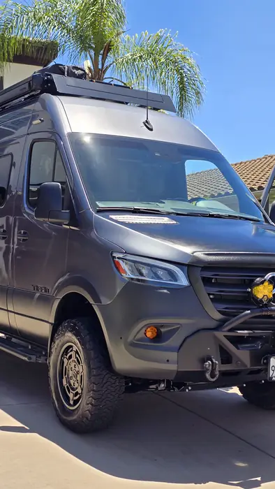 The same Sprinter camper van after a full exterior detail, the grey gone deep and reflective