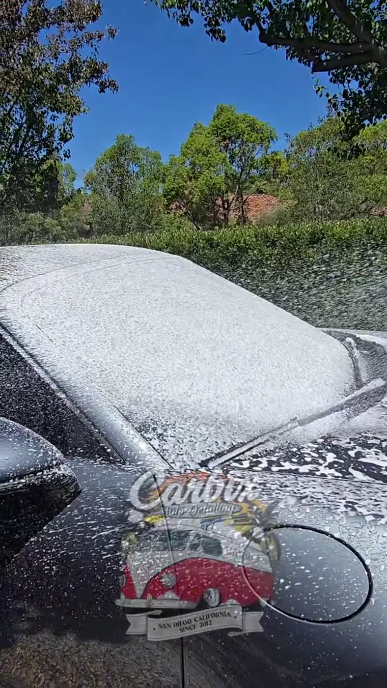 Un Porsche cubierto de espuma durante el proceso de limpieza profunda