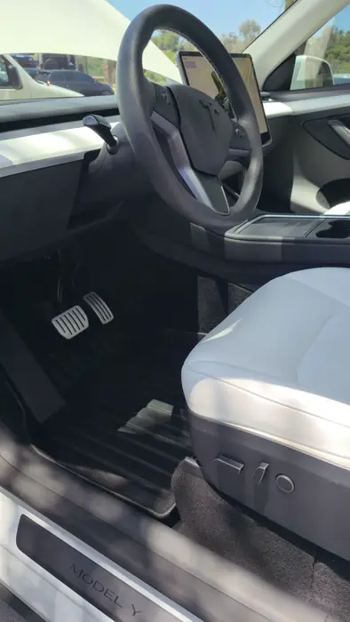 The same Tesla interior after shampooing and hot water extraction
